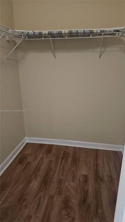 Storage area featuring wood-finish flooring and integrated wire shelving
