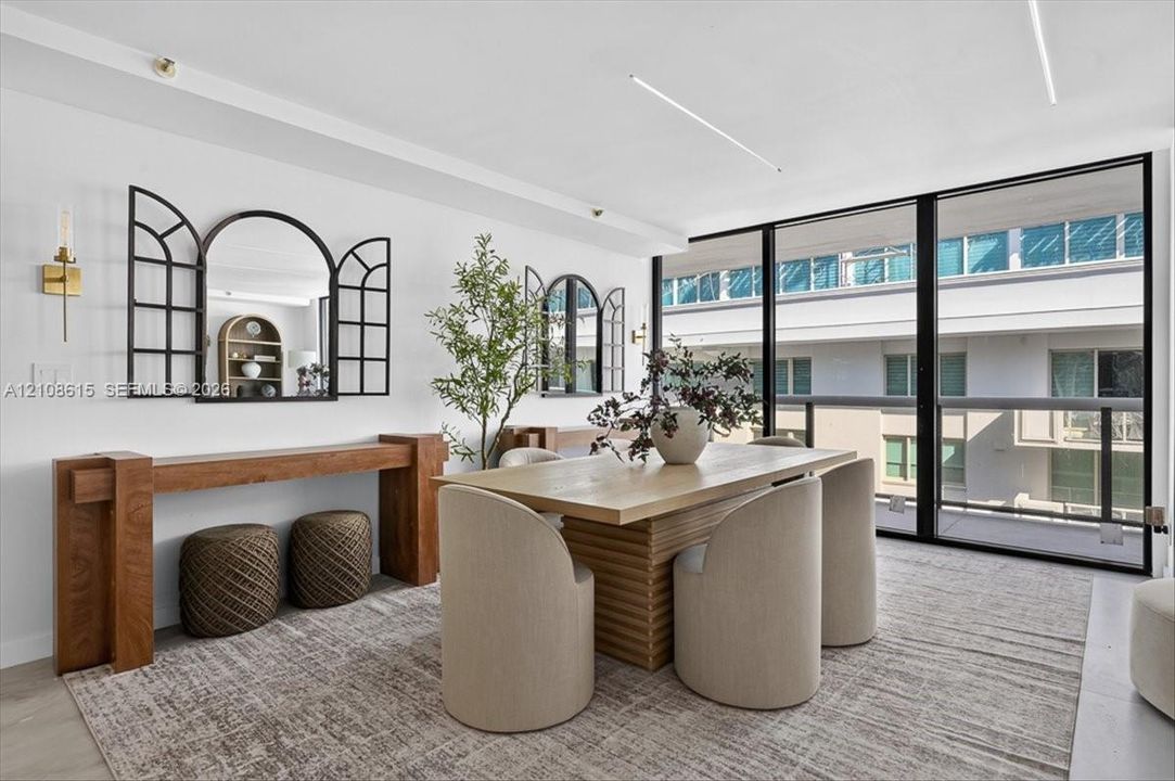 Floor-to-ceiling windows with black framing, wood-finish flooring, and recessed linear lighting