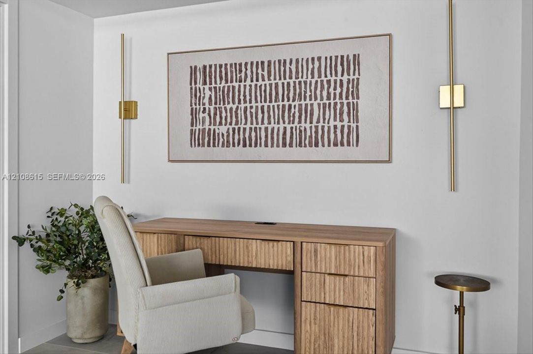 Vertical brass wall-mounted light fixtures with a minimalist aesthetic