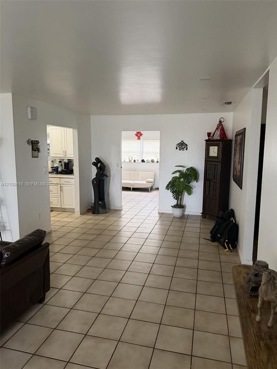 Interior space featuring large-format ceramic tile flooring, neutral wall finishes, and recessed lighting