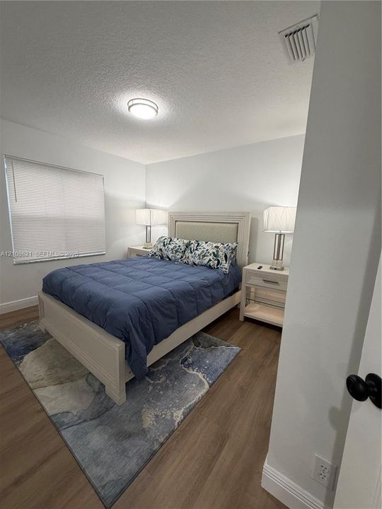 Wood-finish flooring, neutral wall tones, and recessed ceiling lighting