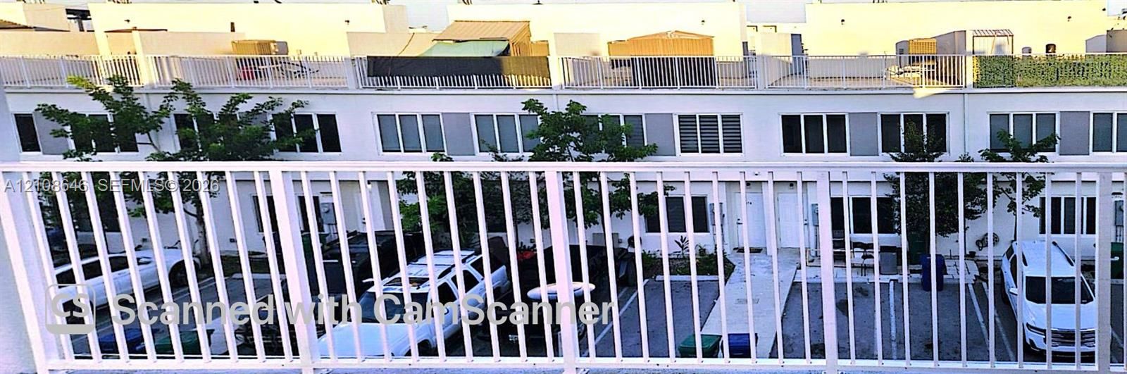 Exterior balcony featuring a white metal railing and flat-roof architectural design