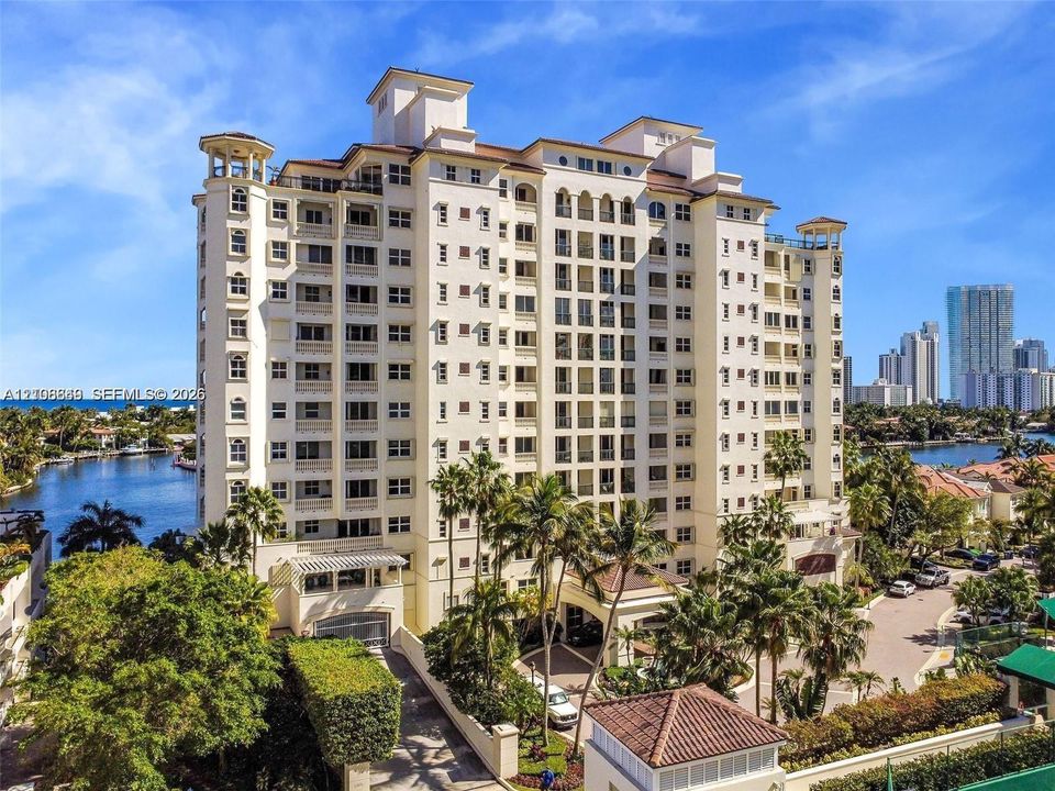 Mid-rise waterfront  building architectural detailing,  clay tile roof, and porte-cochère entry