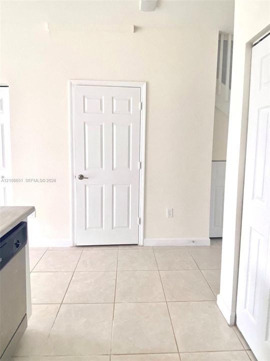 Neutral-toned tile flooring, six-panel interior doors, and clean-finished walls