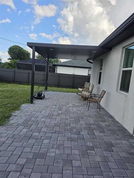 Covered patio featuring paver flooring, recessed lighting, and a fenced backyard