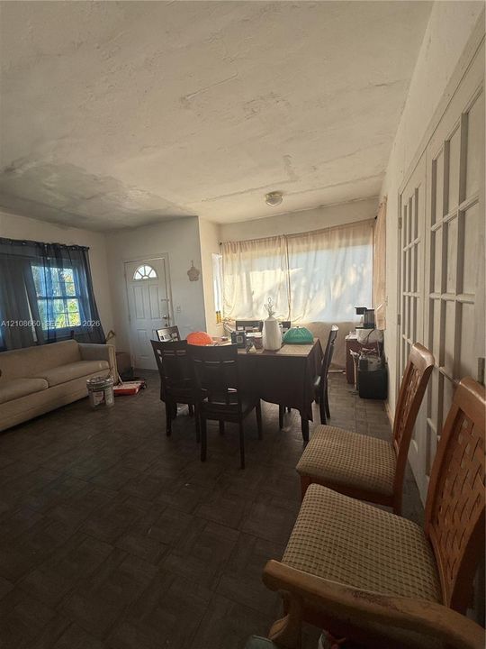 Interior space featuring square-pattern tile flooring, large windows, and multi-pane glass doors