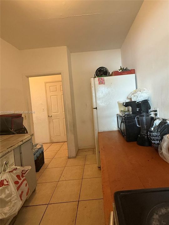 Kitchen area featuring tile flooring and a six-panel interior door