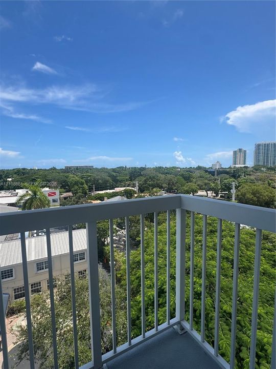 Private balcony with metal railings and concrete flooring