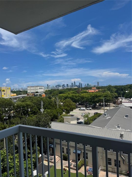Elevated balcony featuring a gray metal railing and panoramic horizon skyline exposure
