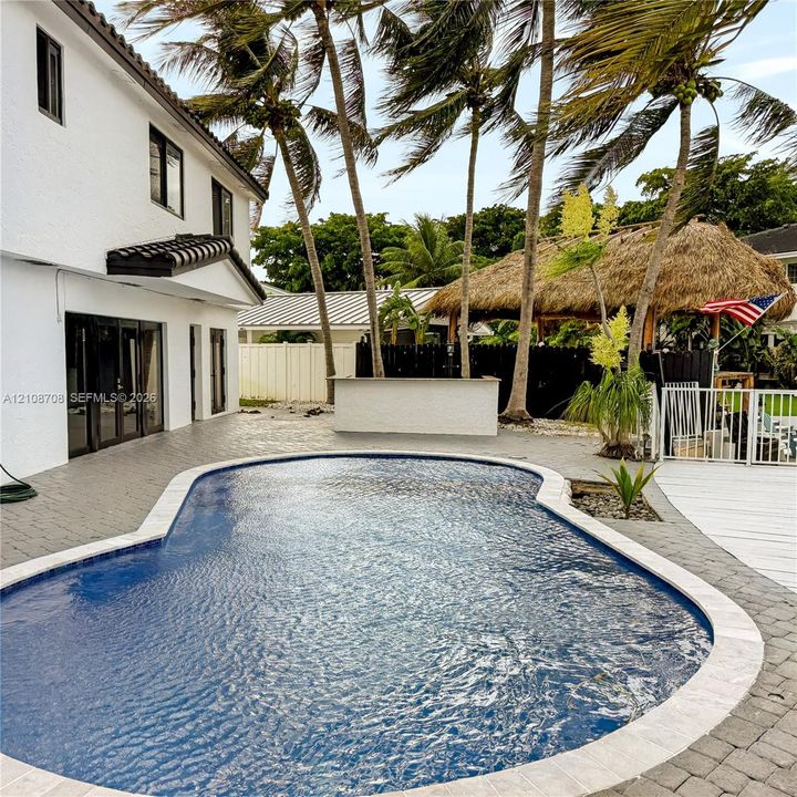 Pool with tiki bar and paver deck