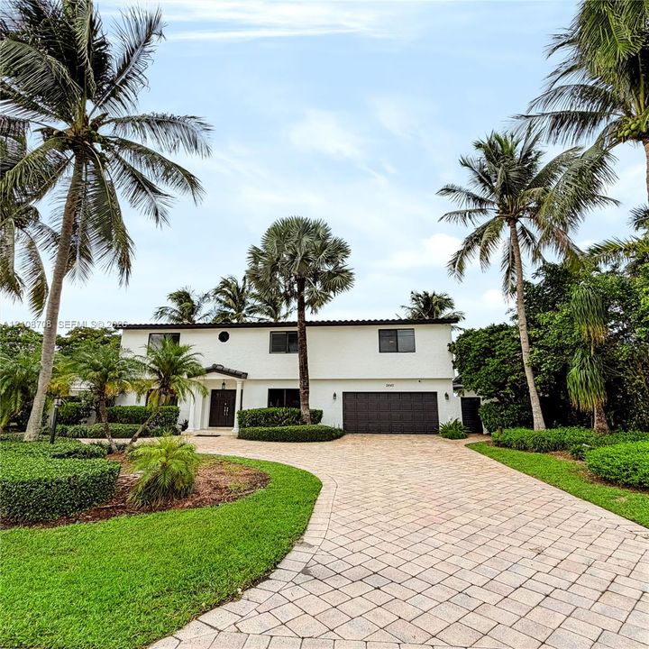Front of the home with paver driveway and garage