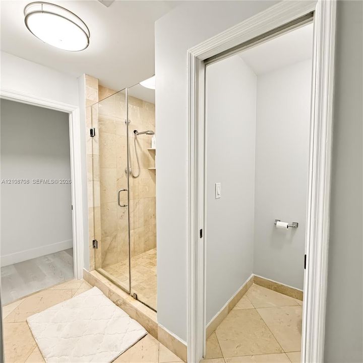 Primary bathroom with glass walk in shower