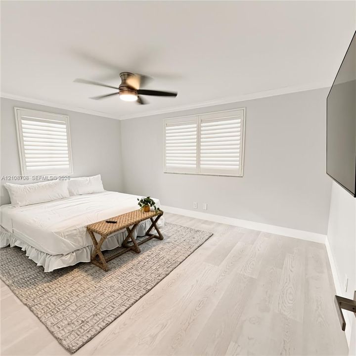 Bedroom with king bed and wood floors
