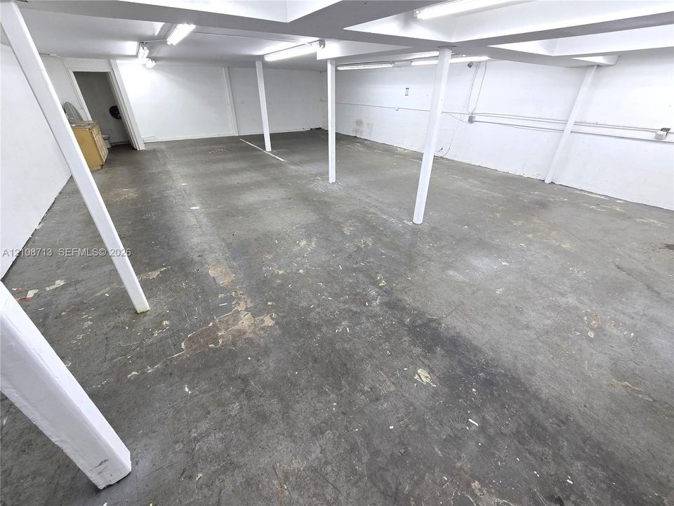 Open floor plan featuring concrete flooring, structural support columns, and recessed lighting