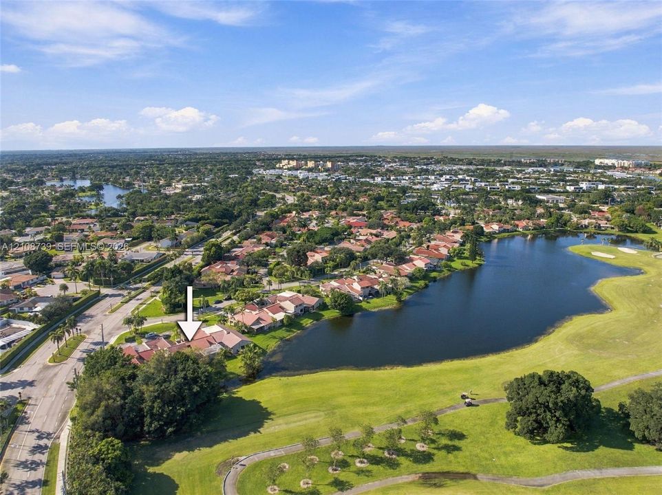 Waterfront estate lot featuring a pristine lake with natural shoreline, manicured lawn grounds with mature landscaping, and prime lakeside positioning within an established residential community