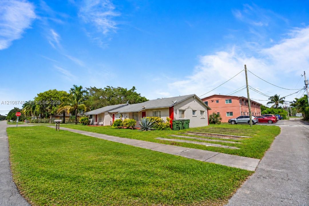 Single-story structure featuring a concrete slab foundation, exterior stucco finish, and dedicated parking spaces