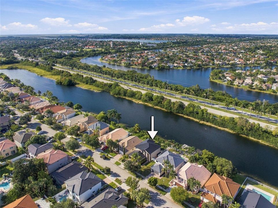 Waterfront property featuring a canal-side position, multi-level architectural design, and a shingled roof
