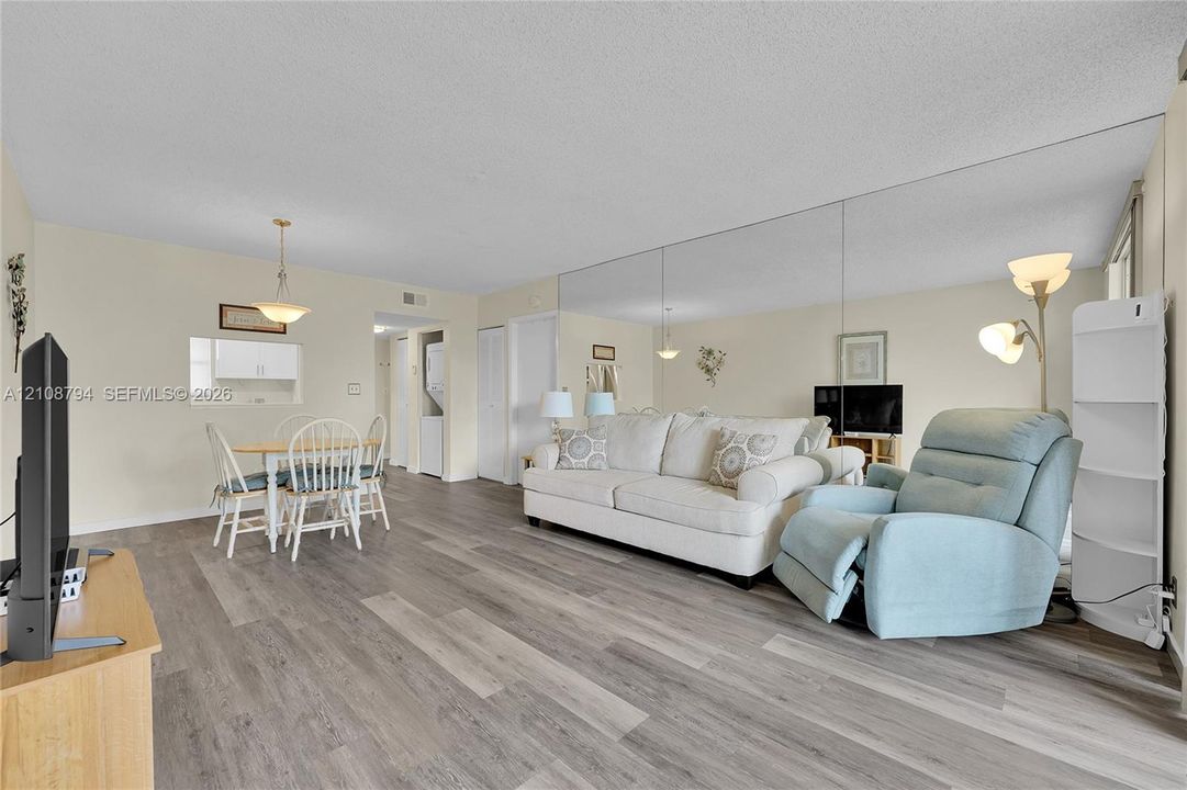 Wood-finish flooring throughout, full-wall mirror, and pendant lighting