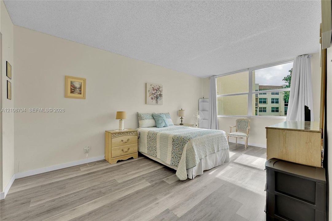 Wood-finish flooring and expansive multi-pane windows providing natural light