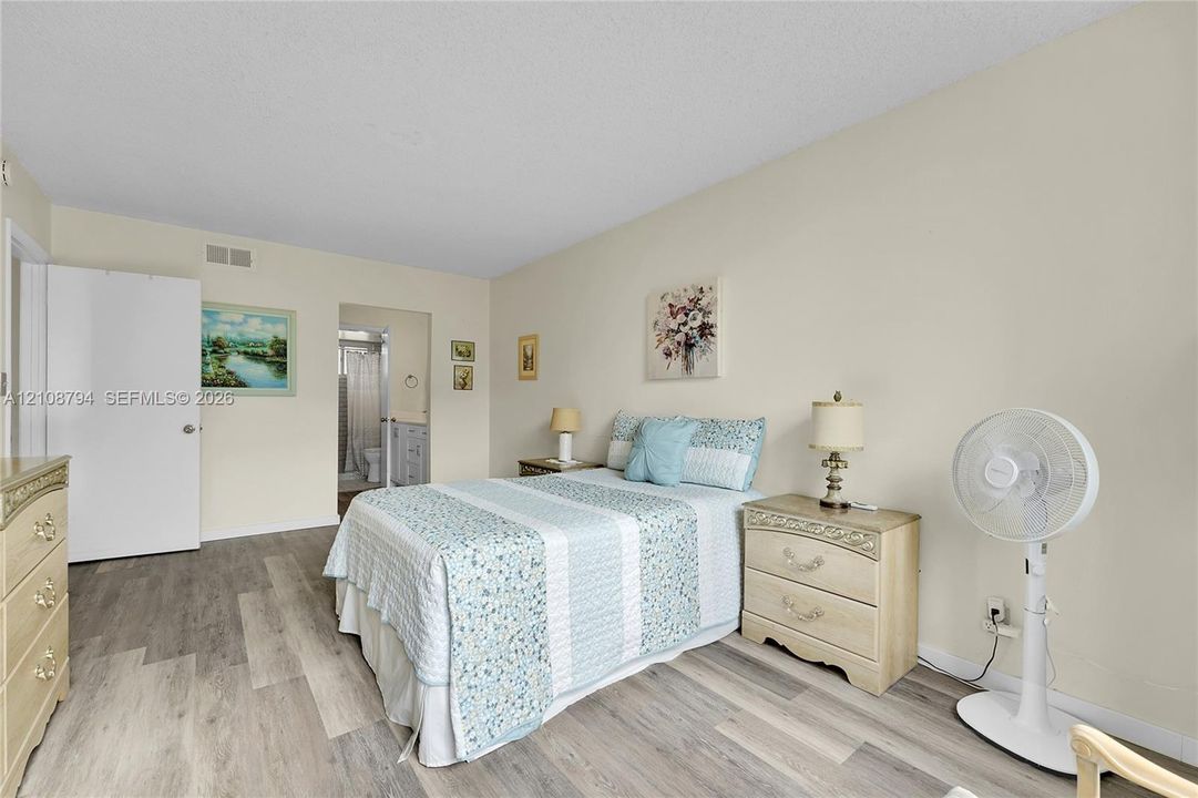 Bedroom featuring wood-finish flooring and a closet with a swing door