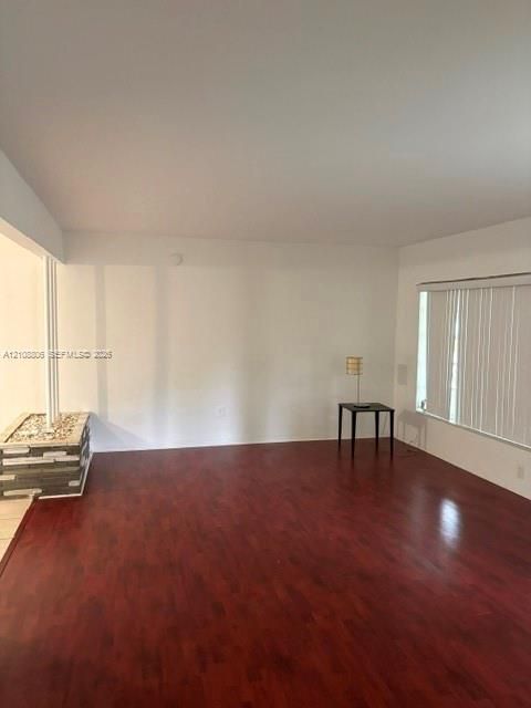 Wood-finish flooring, stone-veneer feature column, and vertical blinds