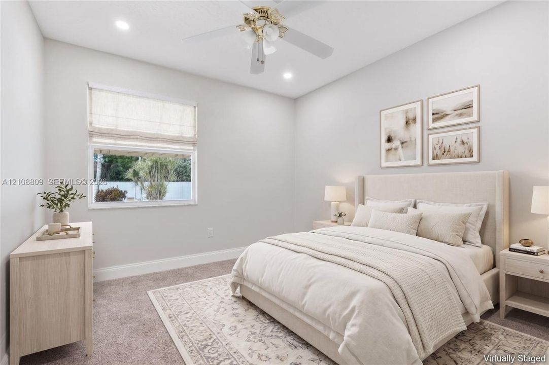 Neutral-toned room featuring plush wall-to-wall carpeting, recessed ceiling lighting, and a multi-blade ceiling fan with a central light fixture