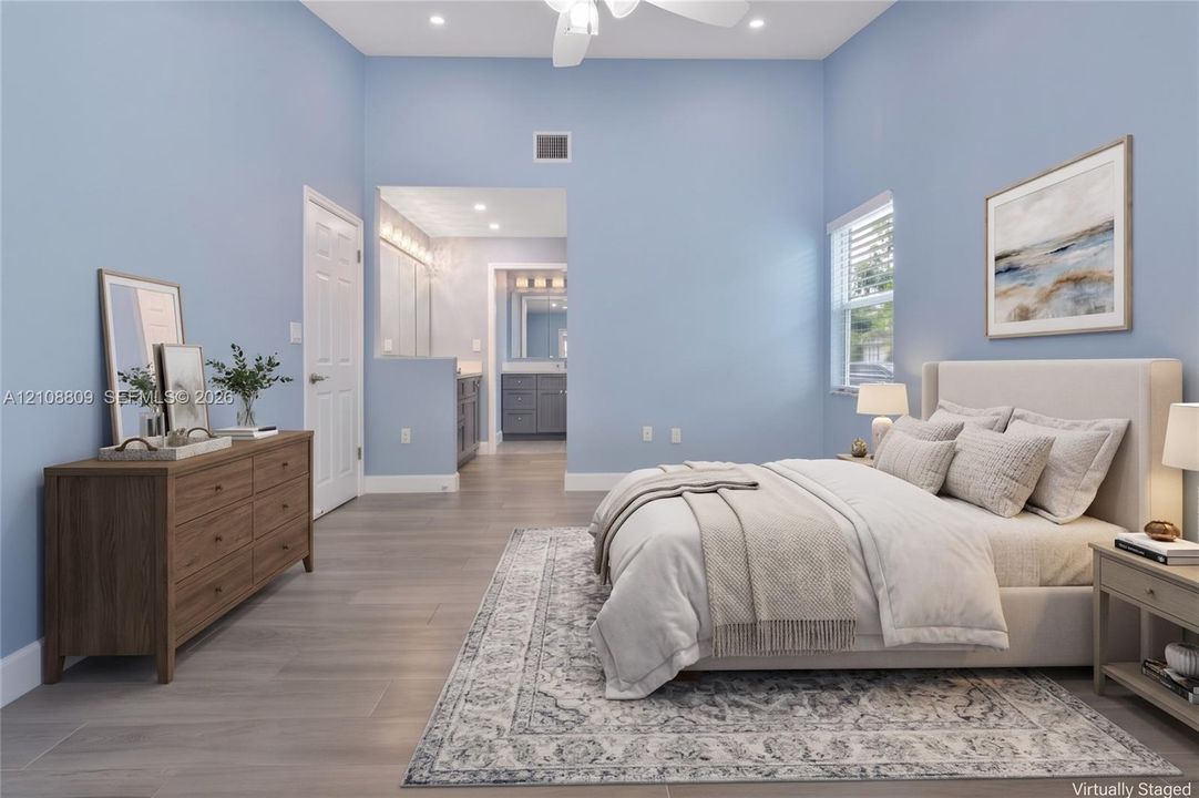 High-ceiling room featuring wood-finish flooring, recessed lighting, a ceiling fan, and window blinds