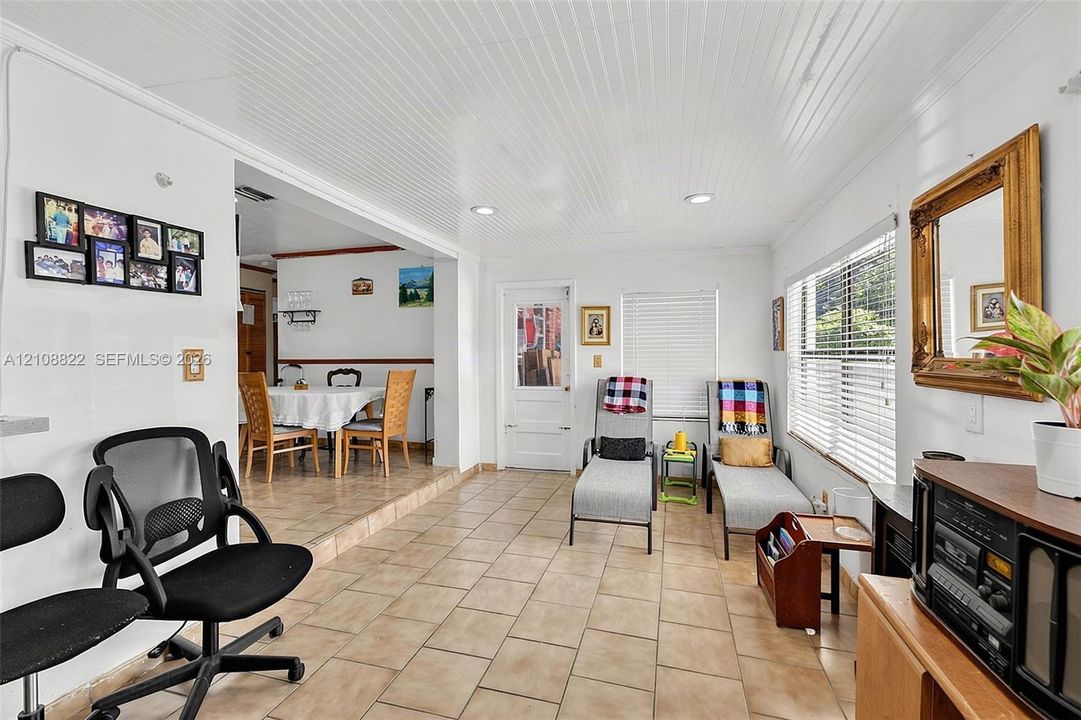 Beadboard ceiling, recessed lighting, and tile flooring throughout