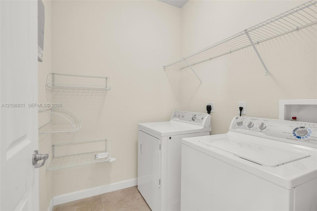 Dedicated utility space featuring wire shelving and wall-mounted metal storage racks