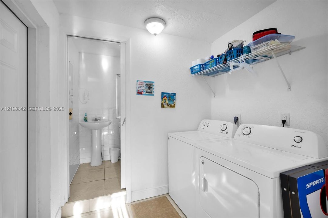 Laundry area with integrated shelving and pedestal sink