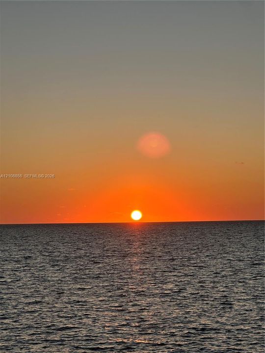Ocean horizon featuring a prominent sunset backdrop