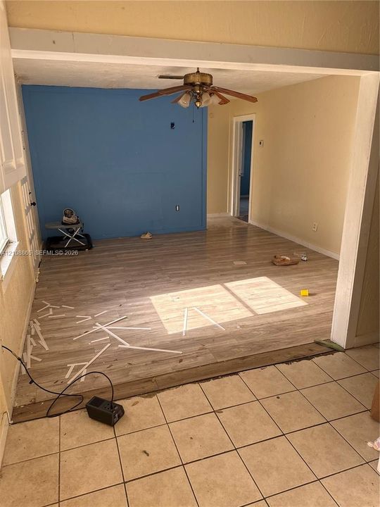 Wood-finish flooring, ceiling fan with integrated lighting, and ceramic tile flooring
