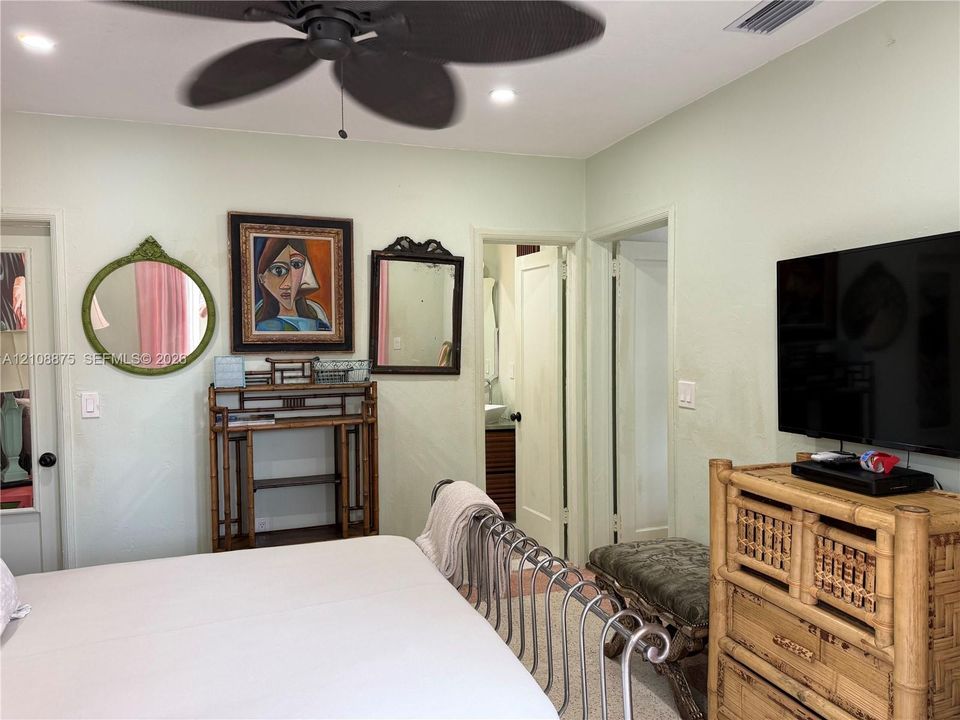 Multi-blade ceiling fan, recessed lighting, and solid-core interior doors