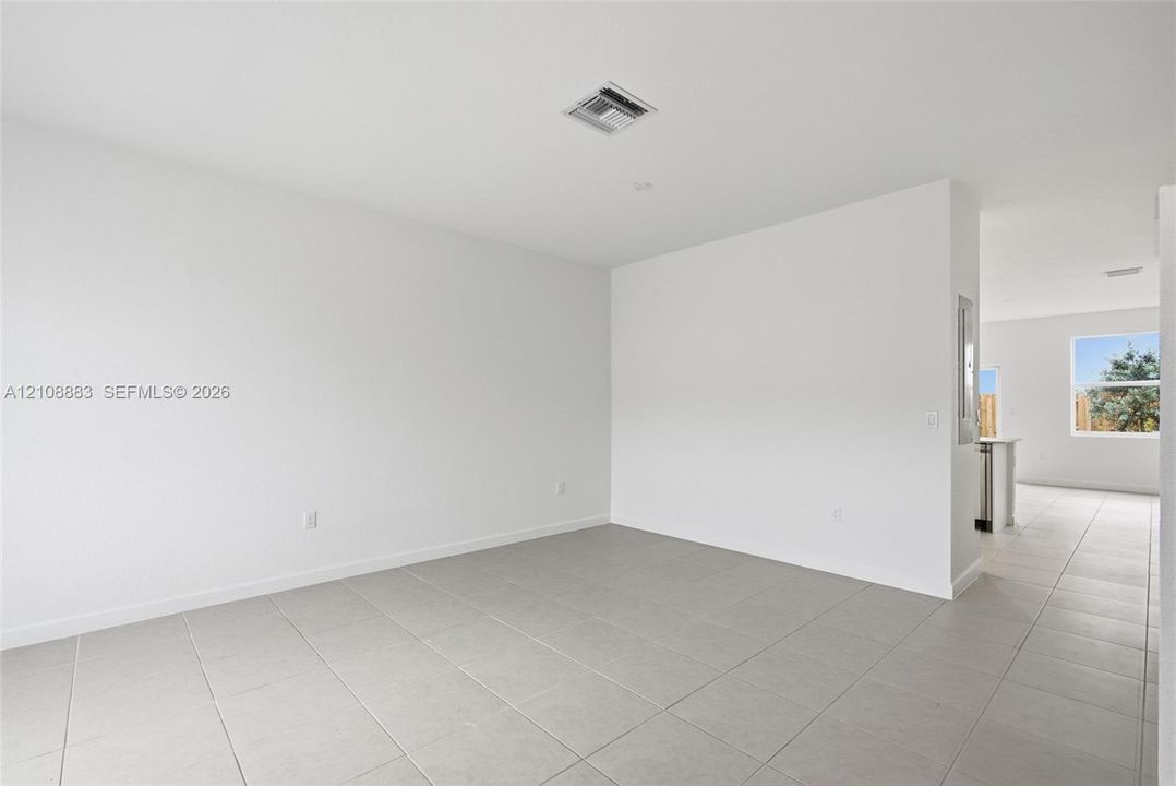 Neutral-toned large-format tile flooring and white wall finishes