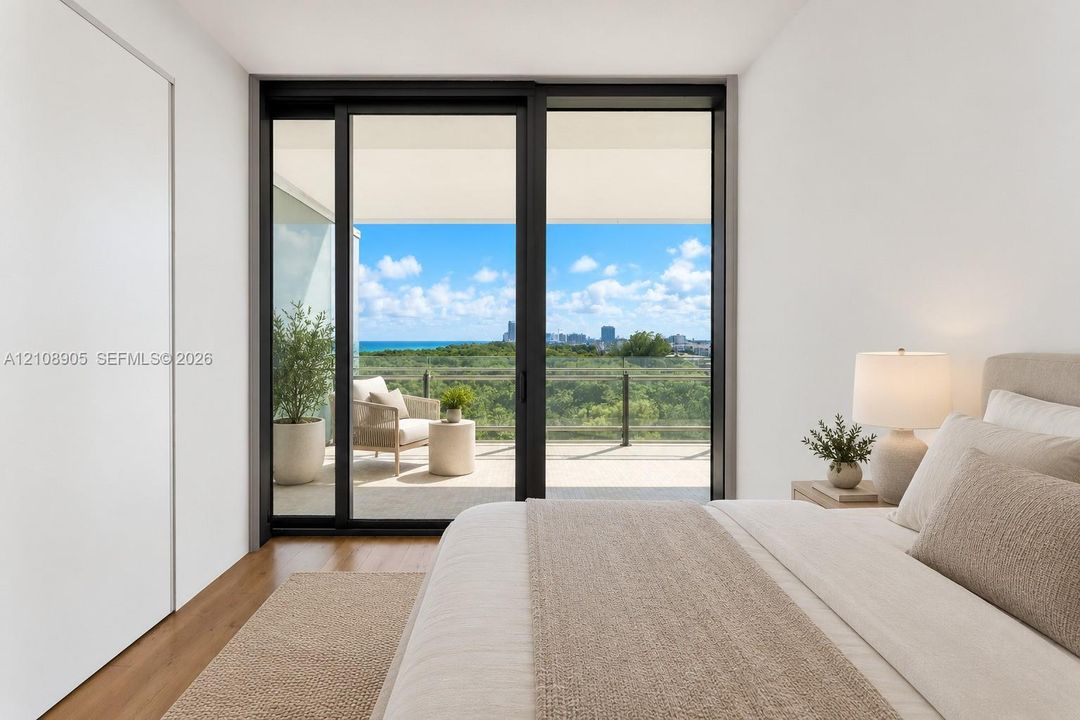 Floor-to-ceiling sliding glass door, wood-finish flooring, and private balcony with glass railing