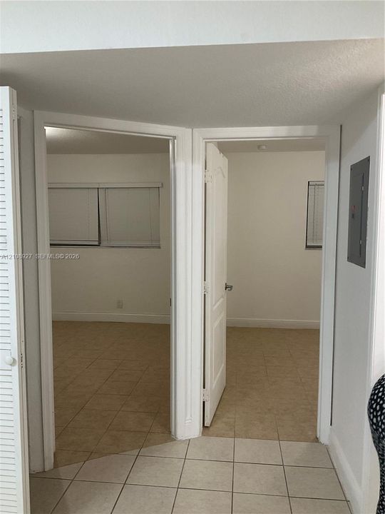Ceramic tile flooring, white interior doors with paneled detailing, and neutral wall tones