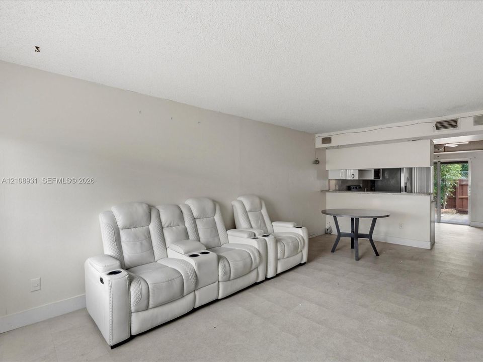 Neutral-toned interior featuring tiled flooring and a kitchen pass-through counter