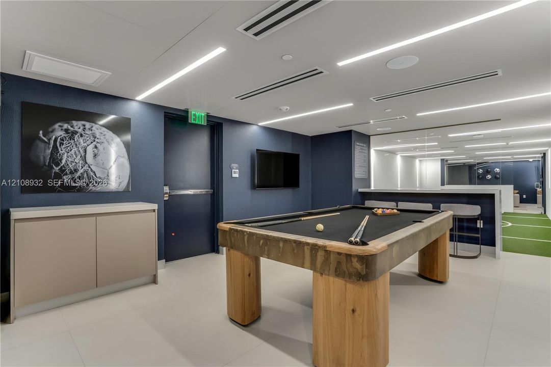 Large-format tile flooring, recessed linear LED lighting, and built-in minimalist cabinetry
