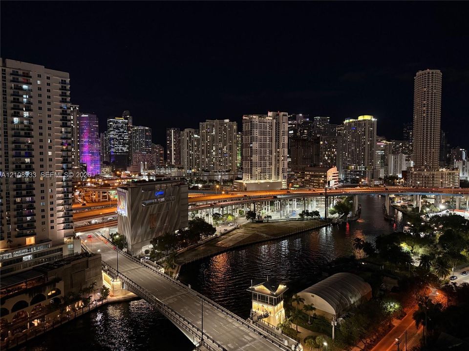 Urban skyline featuring high-rise architecture, multi-level infrastructure, and waterway proximity