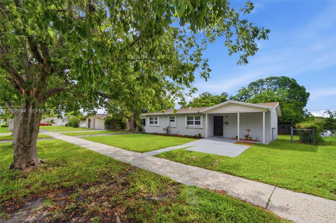 Single-story exterior featuring light-toned horizontal siding, a covered concrete front porch, and a dedicated walkway