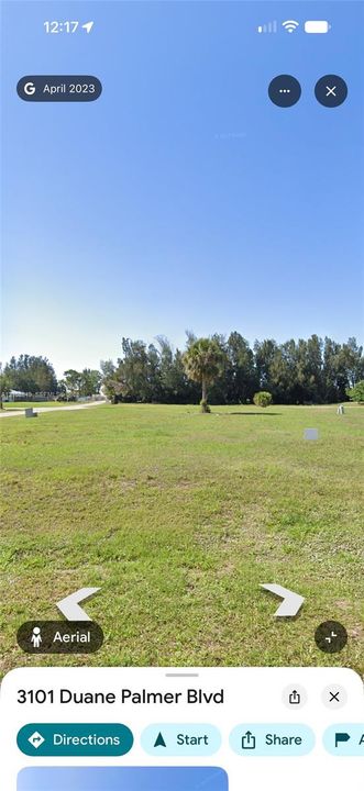 Expansive level lot featuring cleared grass terrain and mature perimeter trees