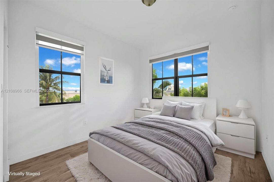 Room featuring wood-finish flooring and dual windows with black frames