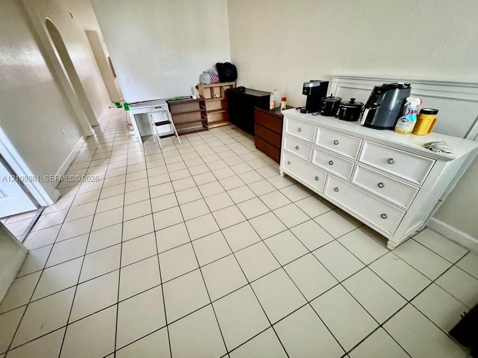 Ceramic tile flooring throughout with an arched entryway