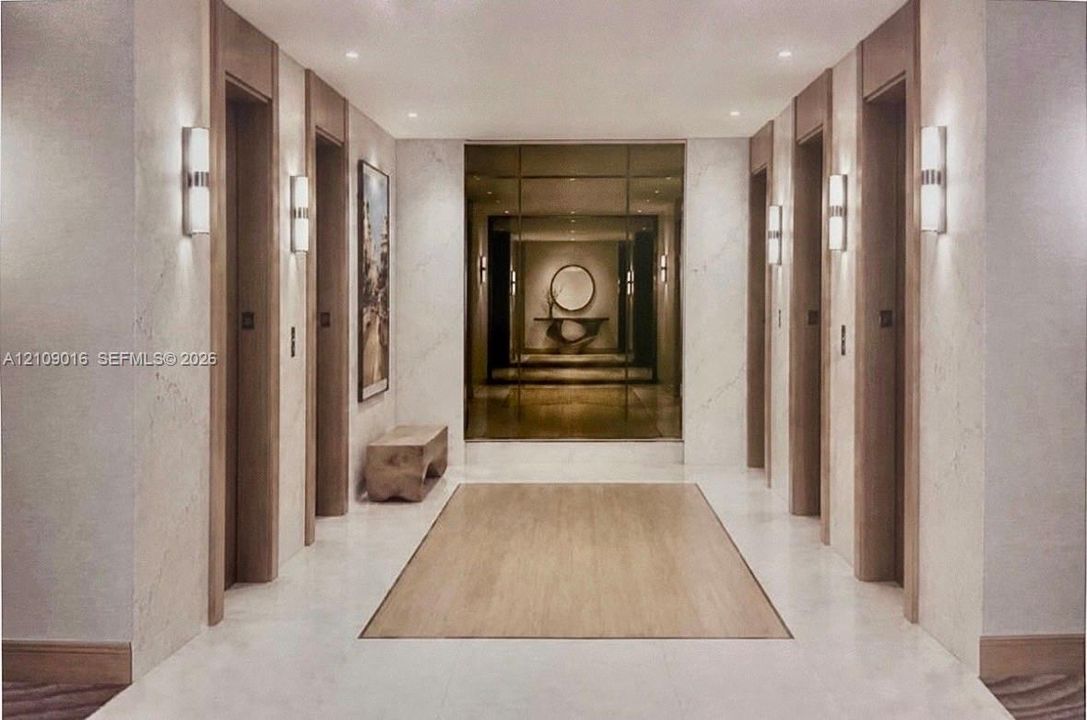 Kitchen area featuring cherry-finish cabinetry with glass-paneled upper doors, stone-composite countertops, and a breakfast bar with a brushed metal support pillar, complemented by large-format tile flooring throughout