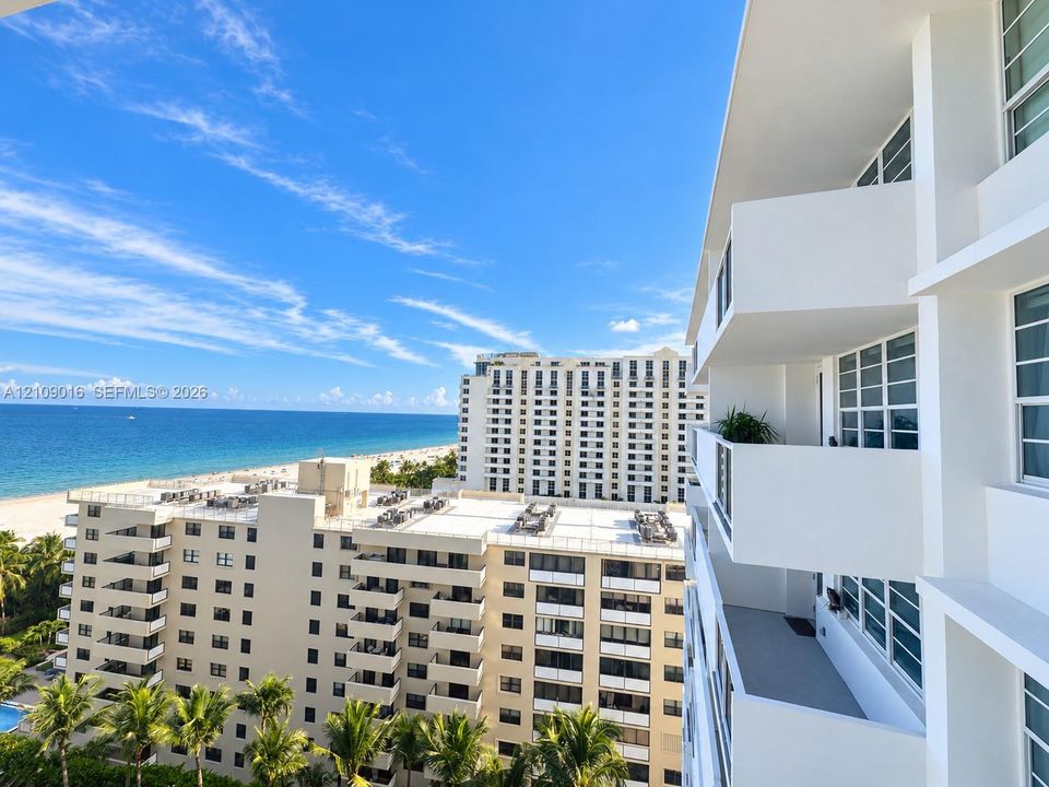 Exterior perspective featuring private balconies, multi-story structural architecture, and direct oceanfront scenery