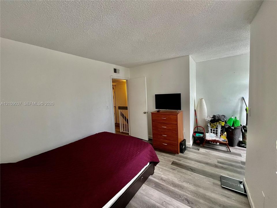 Interior room featuring wood-finish flooring and neutral wall paint