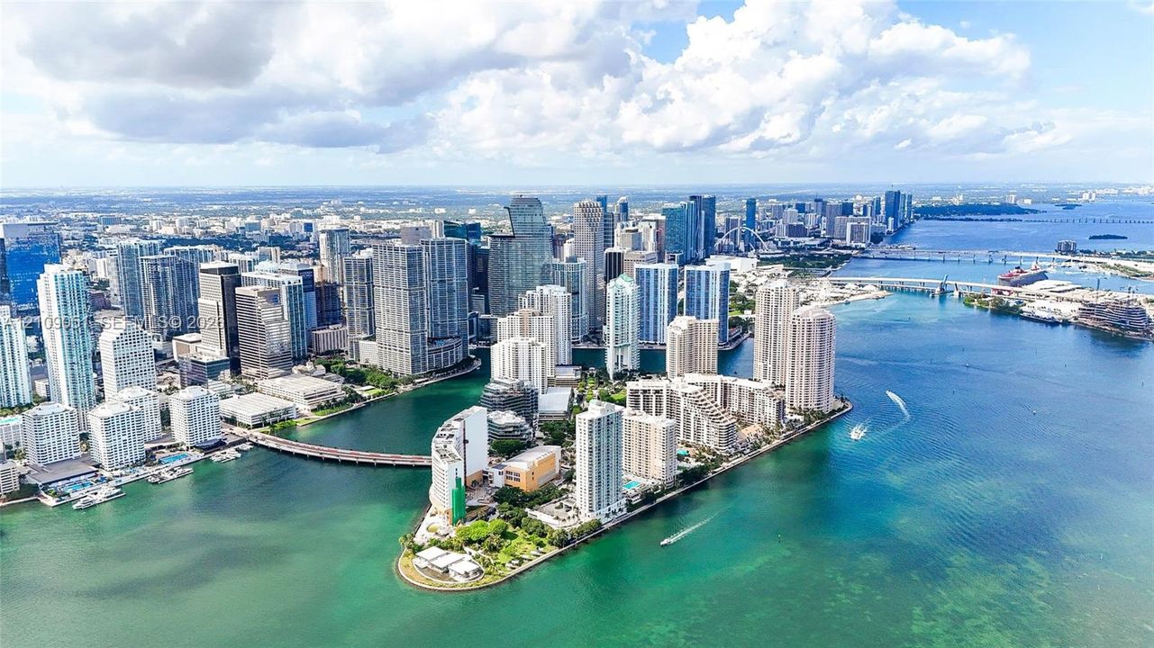 Aerial perspective featuring high-density urban skyline, waterfront positioning, and deep-water access points