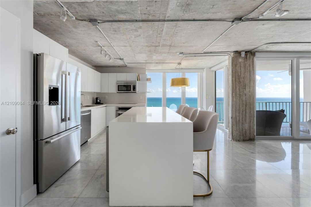 Direct oceanfront access featuring a sandy shoreline and expansive water horizon