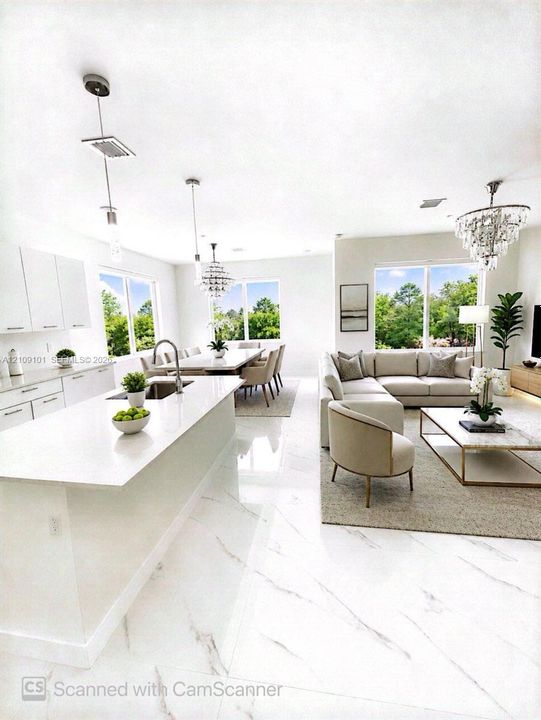 Open-concept interior featuring large-format tile flooring, a kitchen island with stone-finish countertops, crisp white cabinetry, and multi-light crystal chandeliers