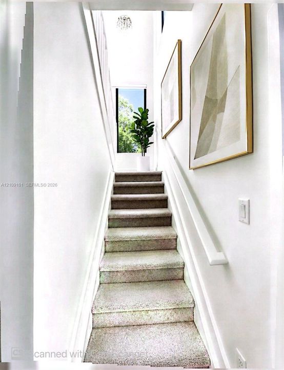 Staircase featuring wall-to-wall carpeting, high ceilings, a flush-mount light fixture, and a vertical window